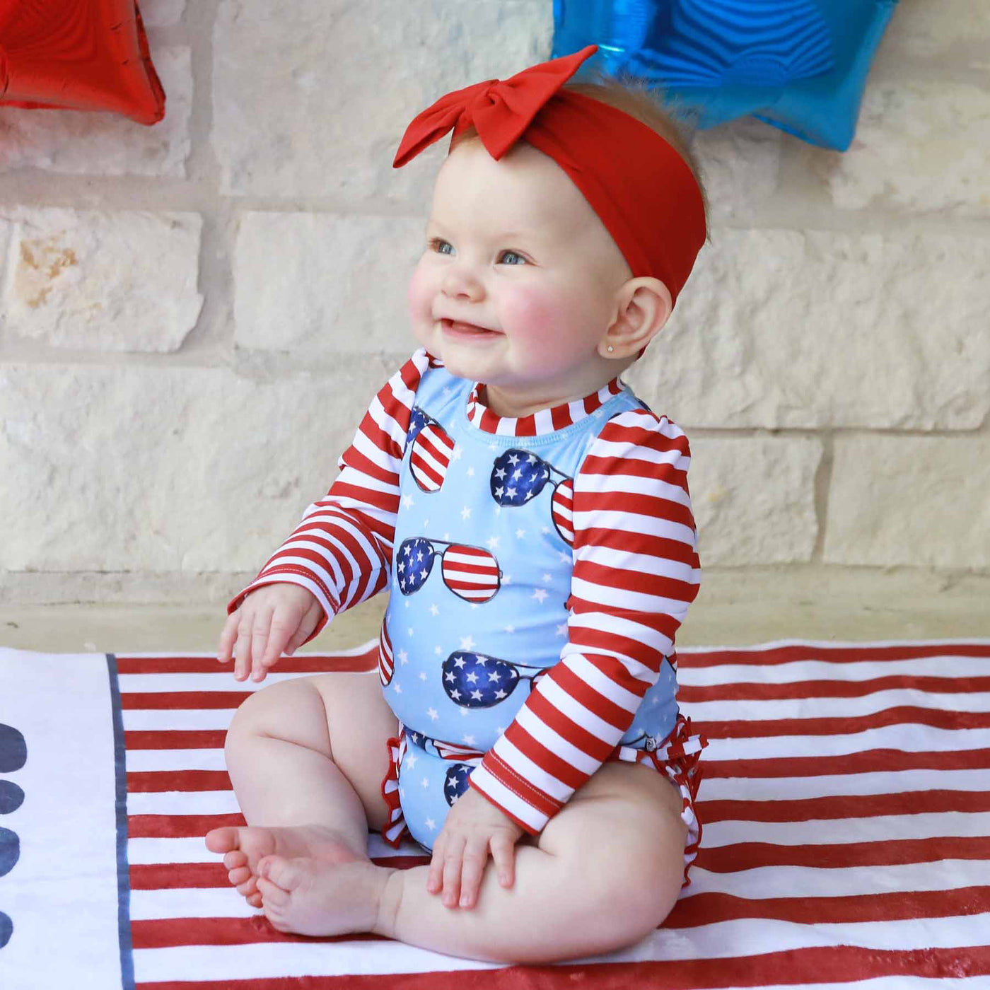 red, white and blue sunglasses swimsuit for babies for the fourth of july 