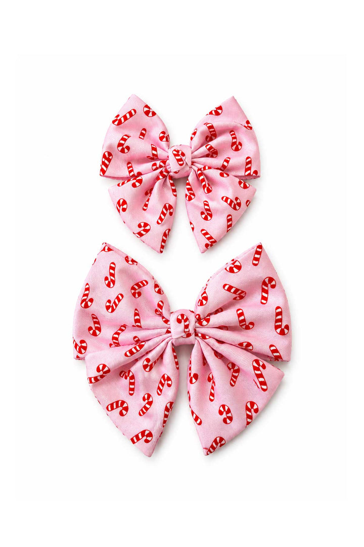 Two Lane & Leash Peppermint Stroll dog sailor bows in pink with candy cane print, shown in small and large sizes on a white background