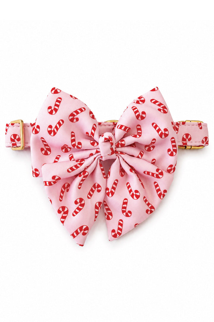 Lane & Leash Peppermint Stroll dog collar in pink with candy cane print and matching oversized sailor bow, gold hardware, on a white background