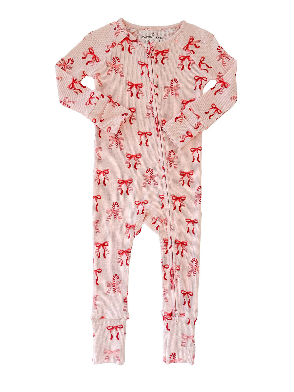 Flat lay of the Caden Lane Peppermint Bows Bamboo Waffle Convertible Zipper Romper featuring a festive bow and candy cane print, crafted from premium bamboo viscose waffle knit with a two-way zipper and convertible footed design.