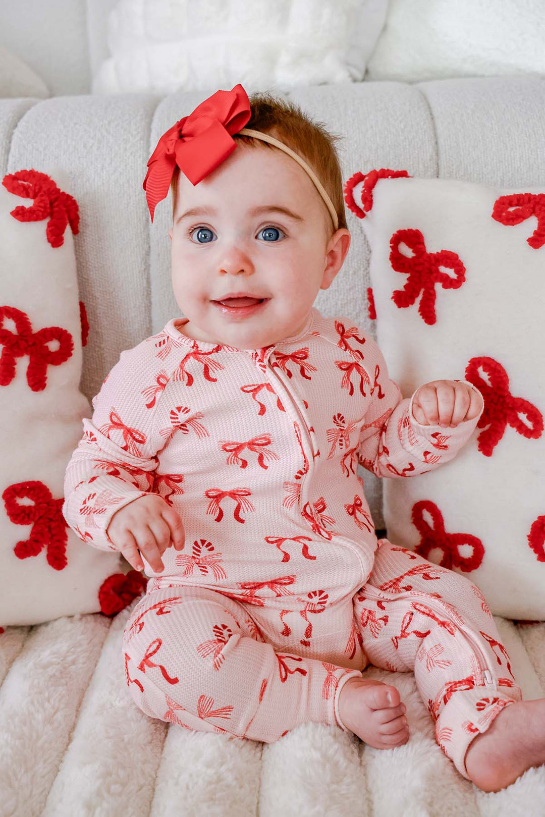Baby wearing the Caden Lane Peppermint Bows Bamboo Waffle Convertible Zipper Romper, featuring festive peppermint bows and candy canes on ultra-soft bamboo viscose waffle knit, perfect for cozy Christmas baby pajamas.