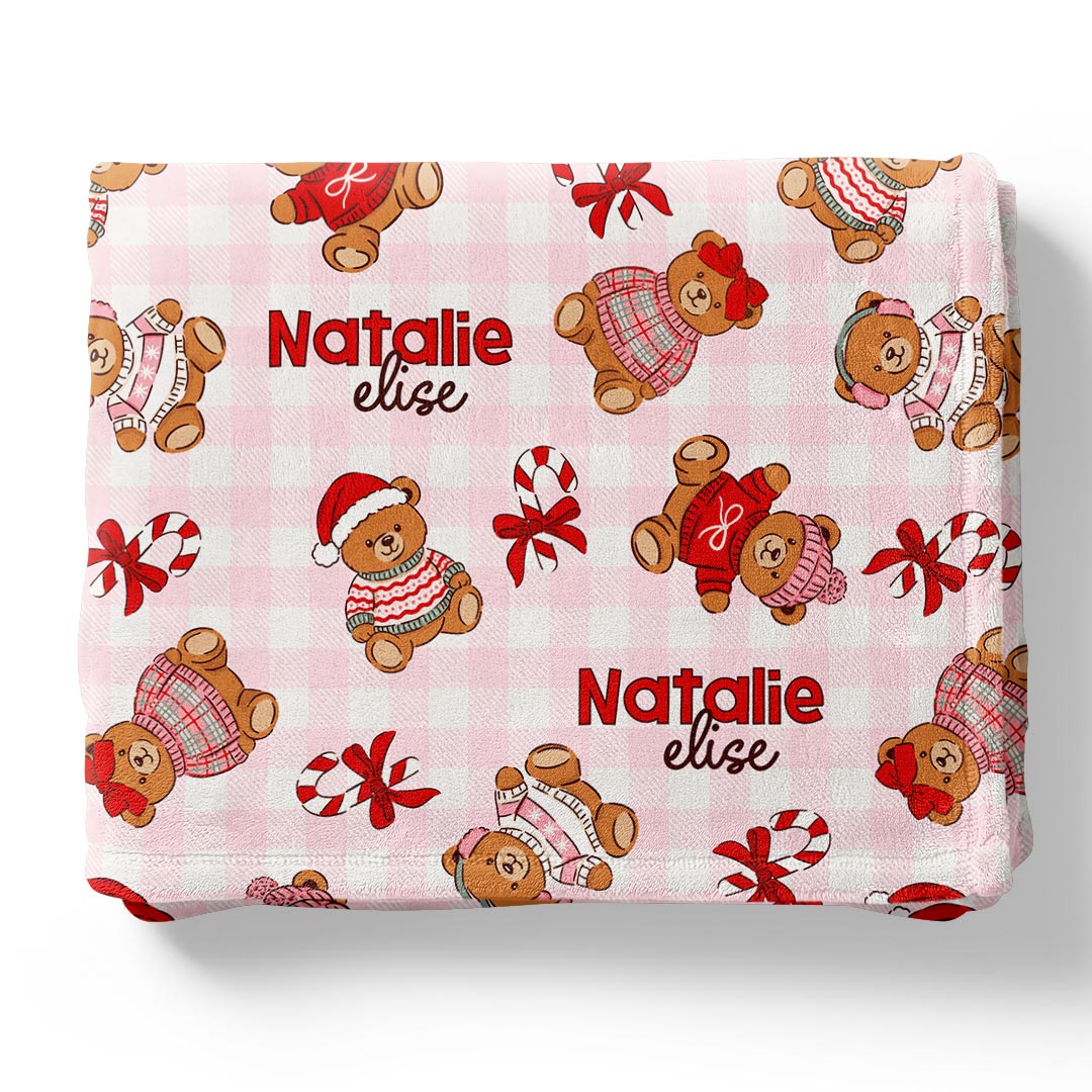 pink gingham personalized christmas blanket for kids with teddy bears in christmas sweaters with hats and sprinkled with candy canes