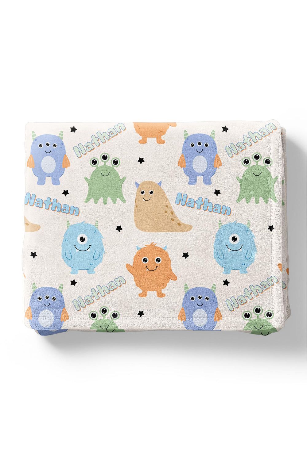 Folded Caden Lane personalized "Nathan" minky blanket in Little Monsters print with blue, orange, tan, and green cartoon monsters and stars