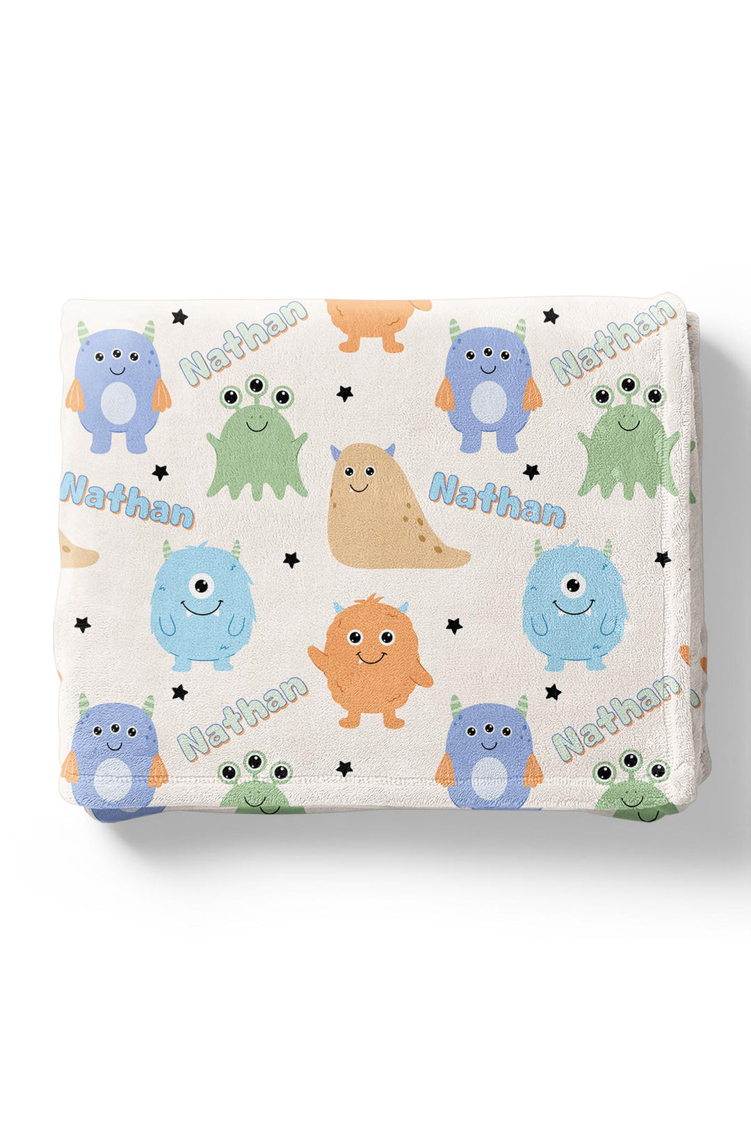 Folded Caden Lane personalized "Nathan" minky blanket in Little Monsters print with blue, orange, tan, and green cartoon monsters and stars