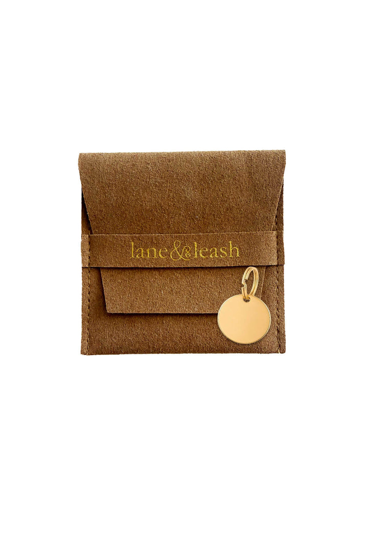 circle id tag and suede bag