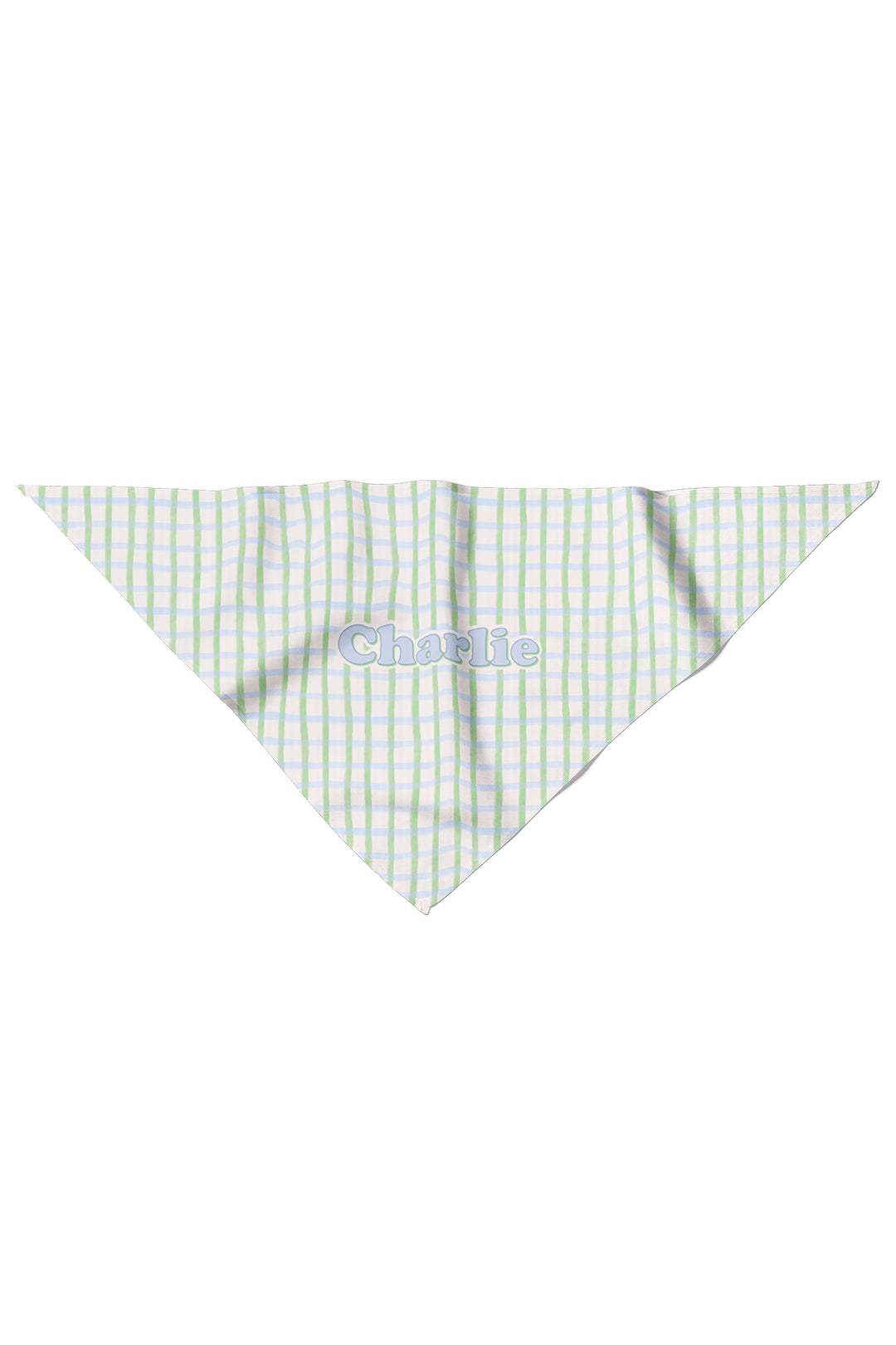 Flat lay of a personalized pet bandana in green and blue picnic plaid, shown as a triangle with the name "Charlie" personalized on the front