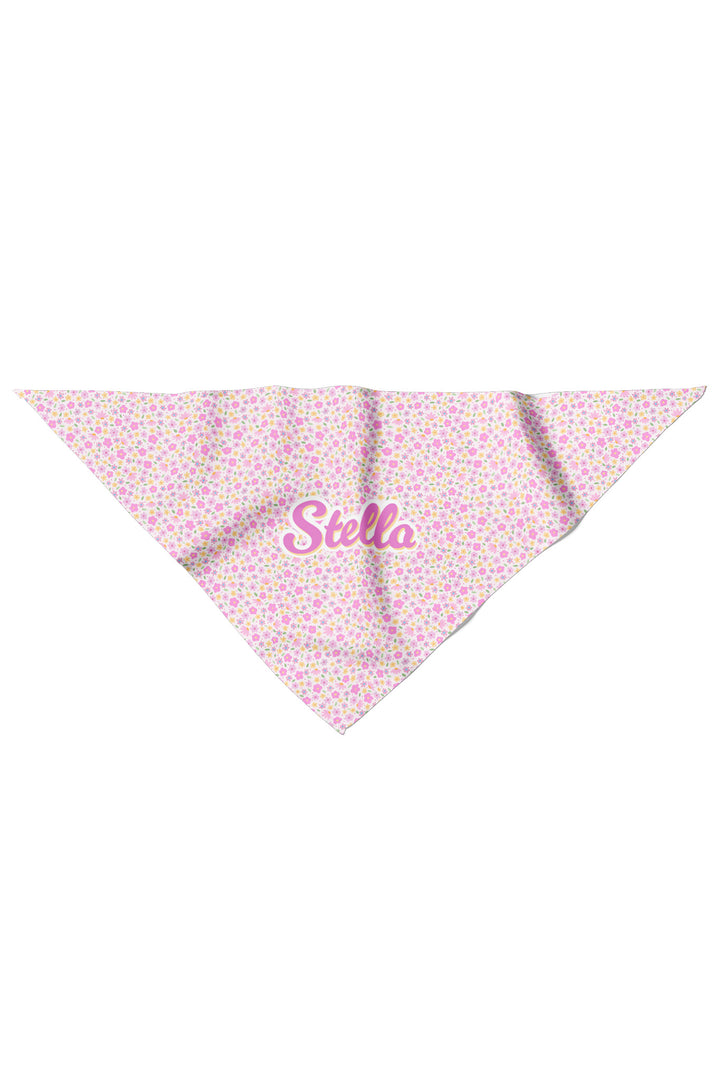 Flat lay of personalized pet bandana in Scattered Blooms print, showing pink, purple, and yellow ditsy floral pattern with pet name in pink script on the front point
