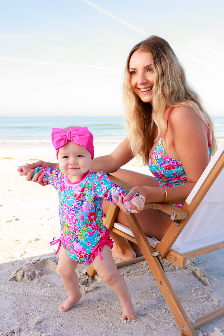 mom and daughter on the beach in petal splash matching swimsuits 