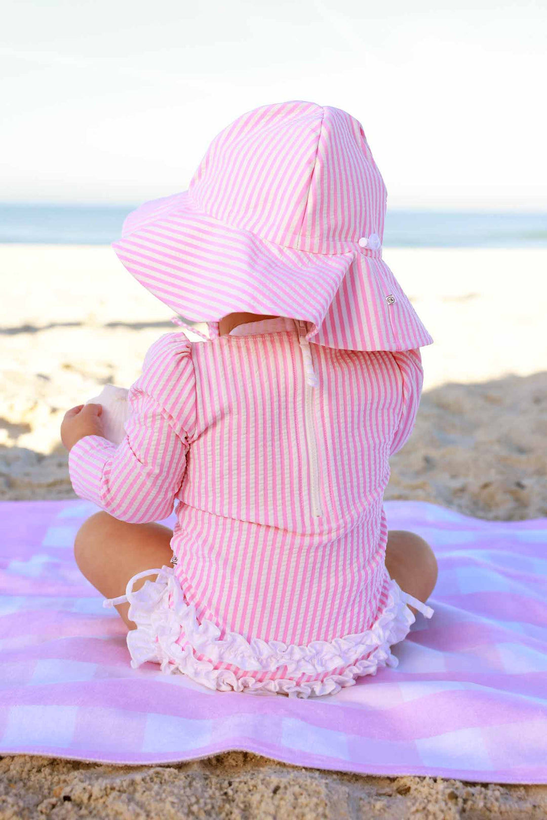 pink seersucker ruffle bottom swimsuit with matching sun hat