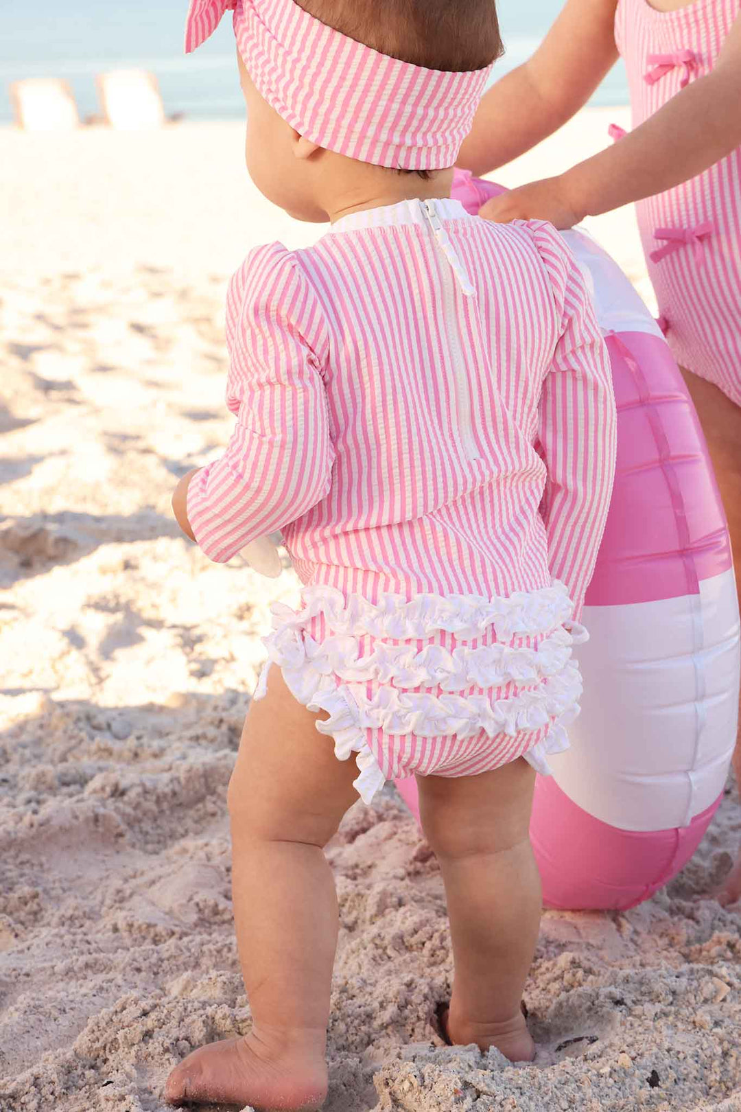 pink seersucker ruffle bottom swimsuit for girls with matching swim bow 