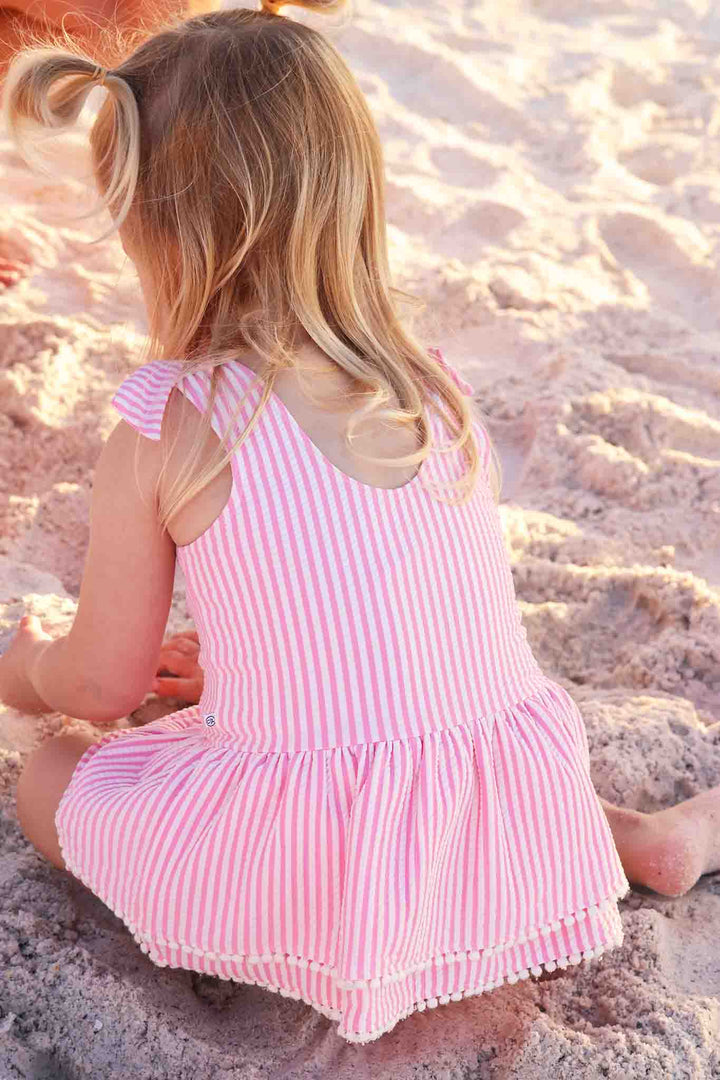 closeup of pink seersucker one piece swimsuit with skirt 