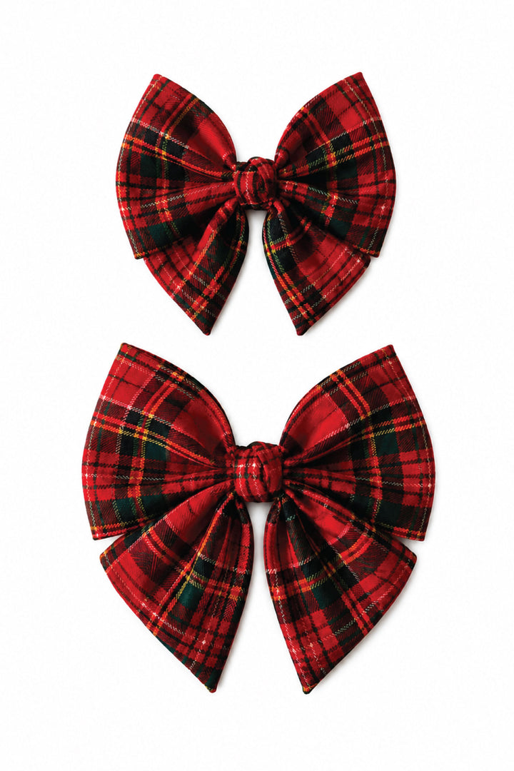 Two Lane & Leash Plaid Tidings dog sailor bows in red tartan plaid, shown in small and large sizes on a white background