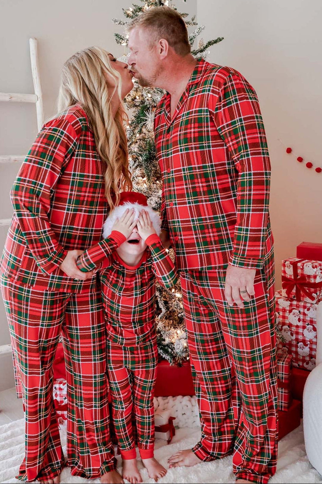 Family wearing matching Caden Lane Christmas bamboo plaid pajamas in a classic red and green tartan print, creating festive holiday memories in coordinating Christmas sleepwear.