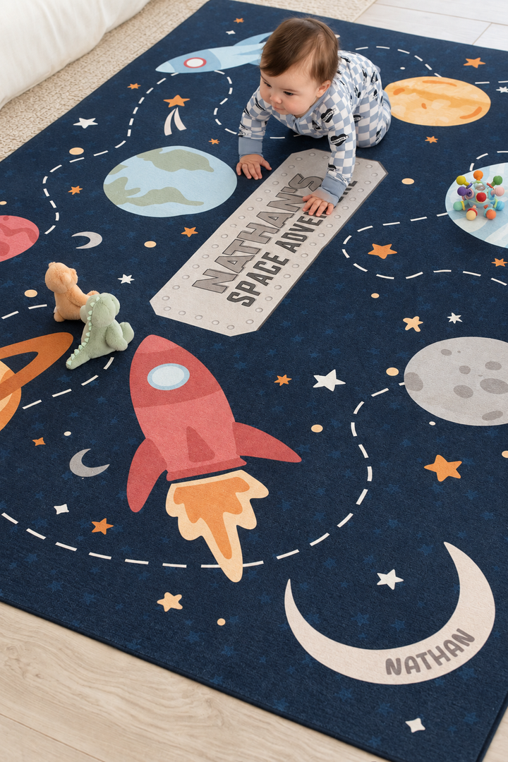 Baby playing with plush toys on a personalized Caden Lane outer space playroom rug with planets, stars and a red rocket ship.