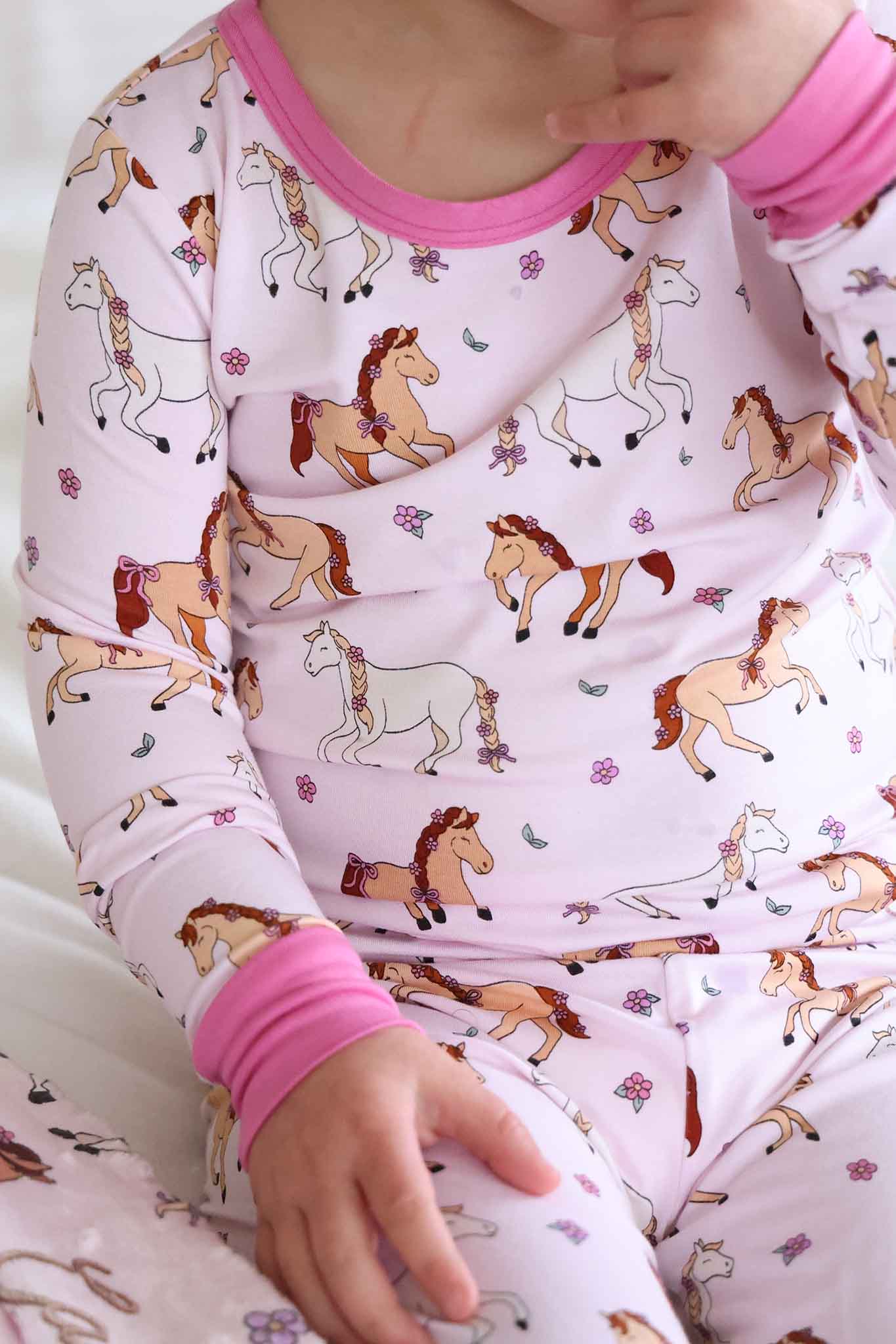 closeup of pony club pink bamboo two piece pajama set for girls 