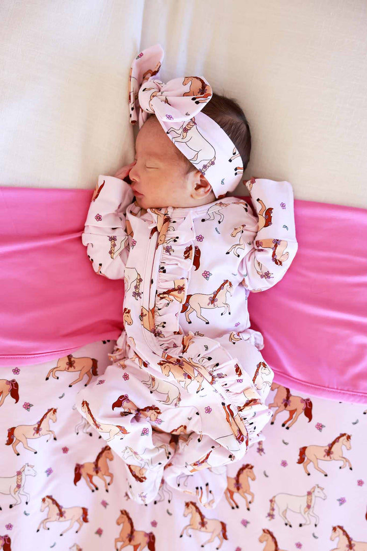 side view of pony club pink headwrap with matching ruffle zipper footie