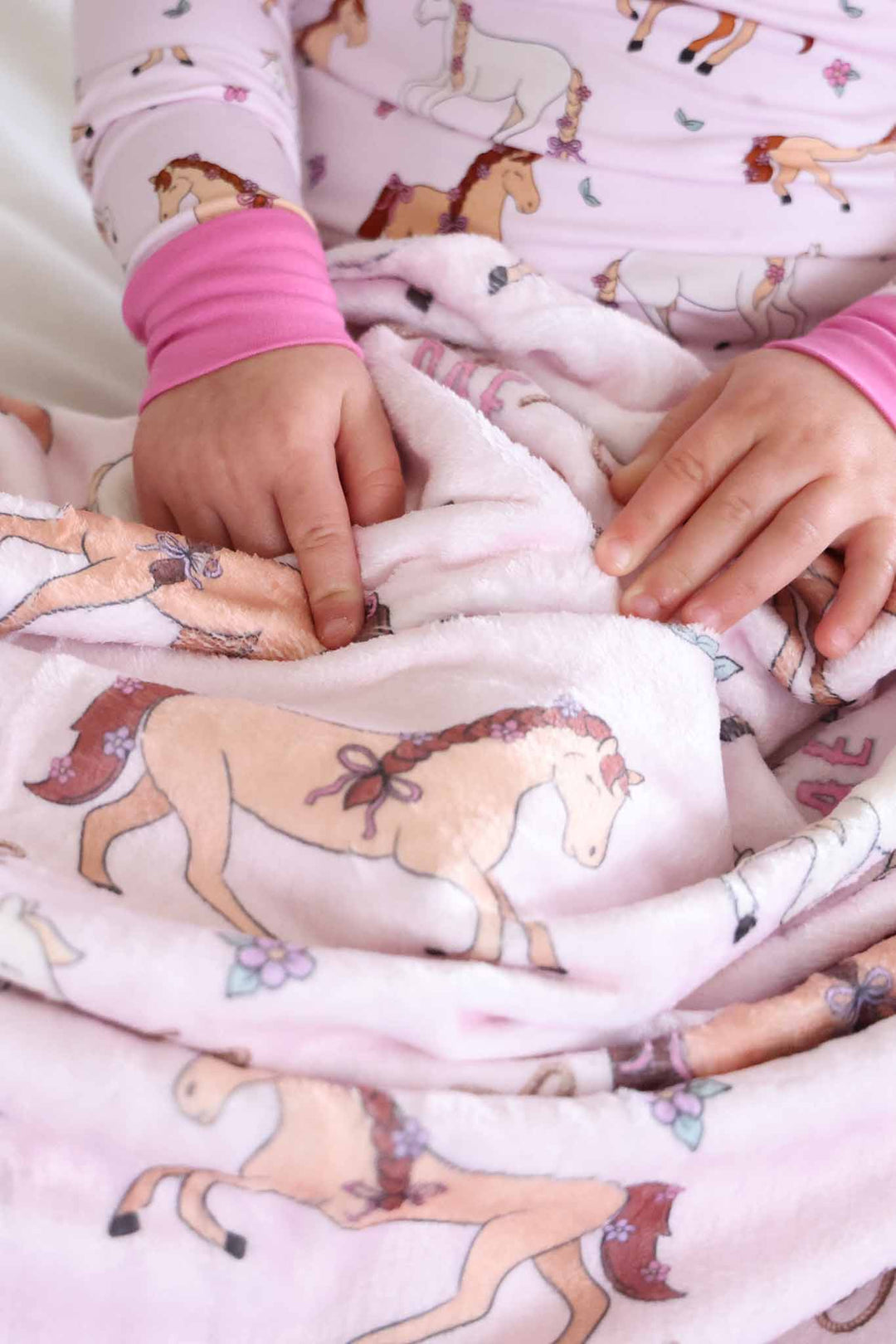 closeup of pony club pink personalized blanket for girls 