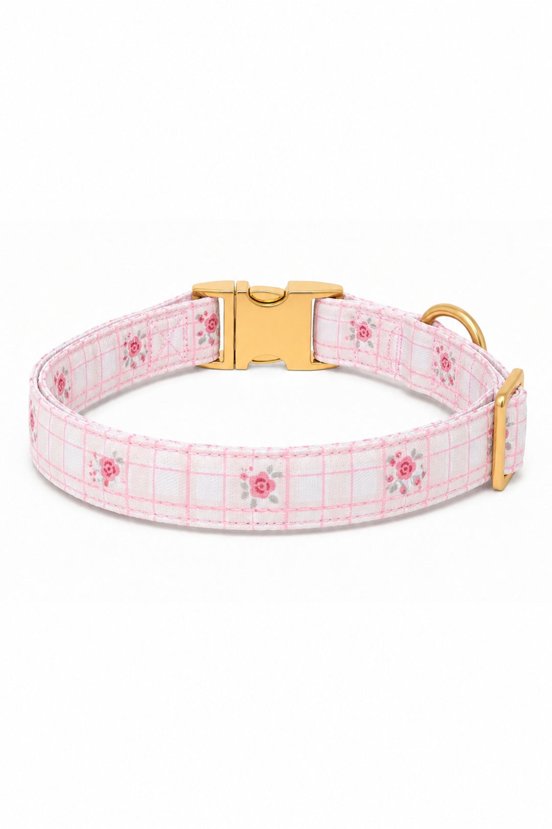 A Lane & Leash light pink and white plaid dog collar with small pink floral motifs, featuring a gold-tone quick-release buckle and a gold-tone D-ring, shown on a plain white background.