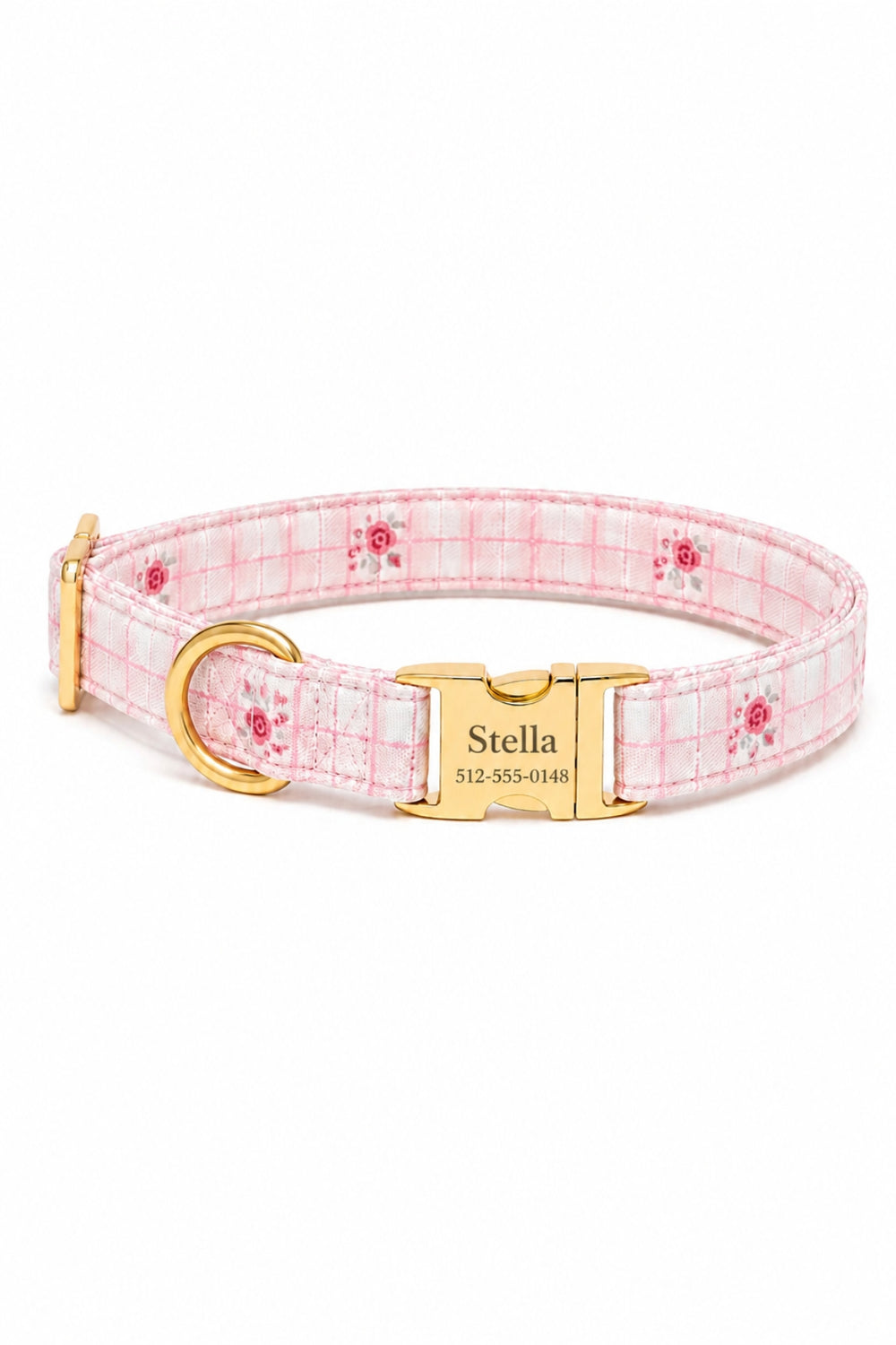 A Lane & Leash pink and white plaid dog collar with a small red rose pattern, featuring a gold-tone metal buckle engraved with the name 'Stella' and a gold D-ring.