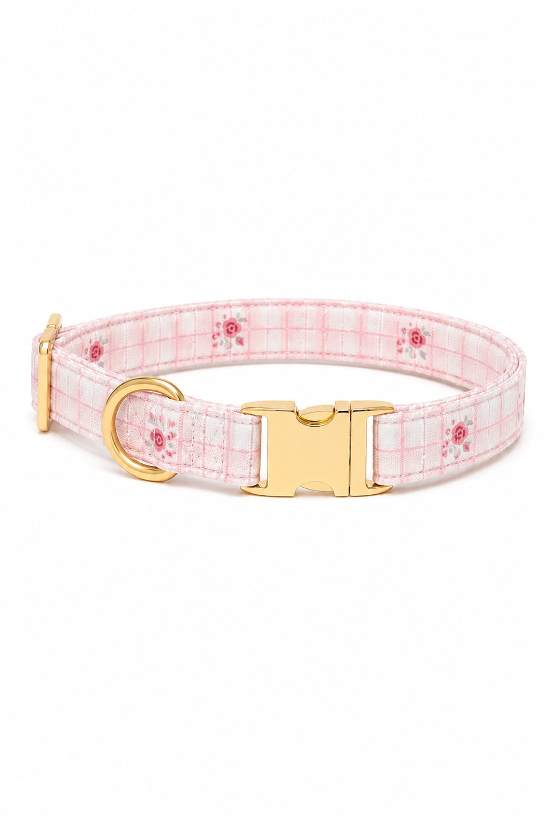 A Lane & Leash light pink and white plaid dog collar with small red floral accents and shiny gold-tone hardware, shown on a plain white background.