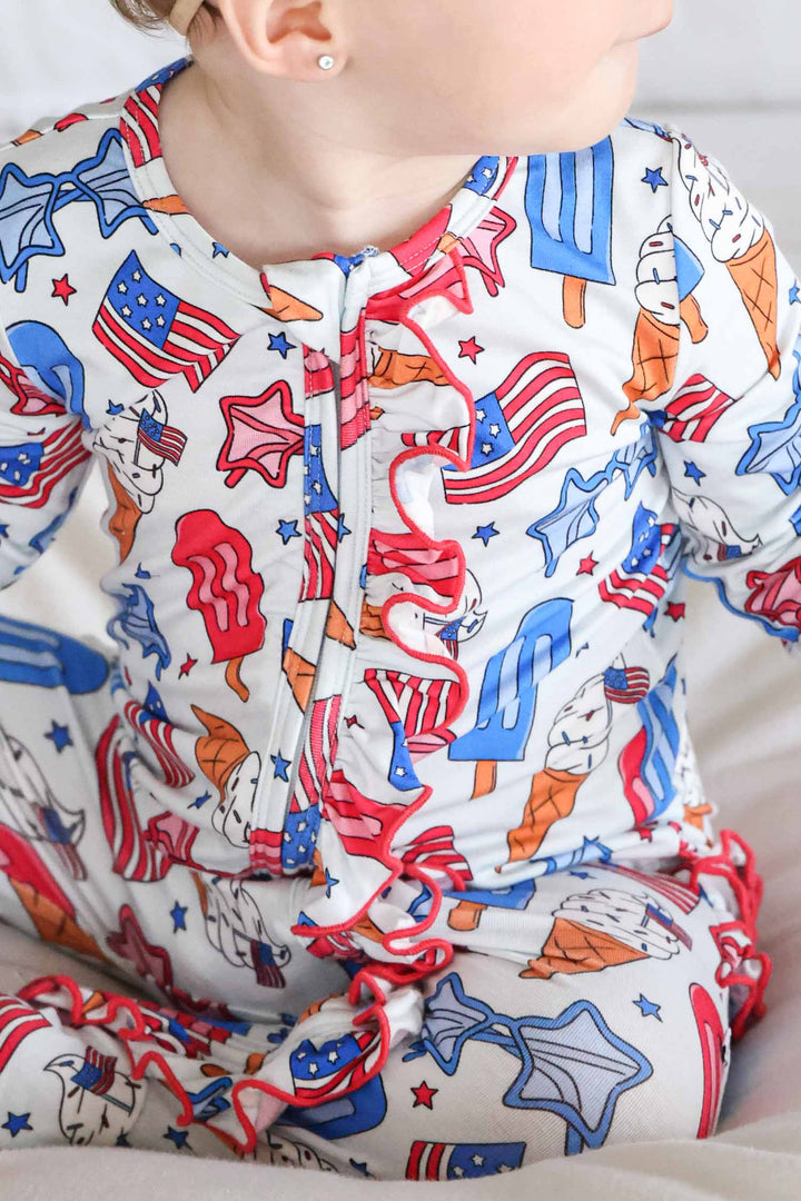 close-up of red white and cool ruffle zipper footie - caden lane bamboo 4th of july baby pajamas