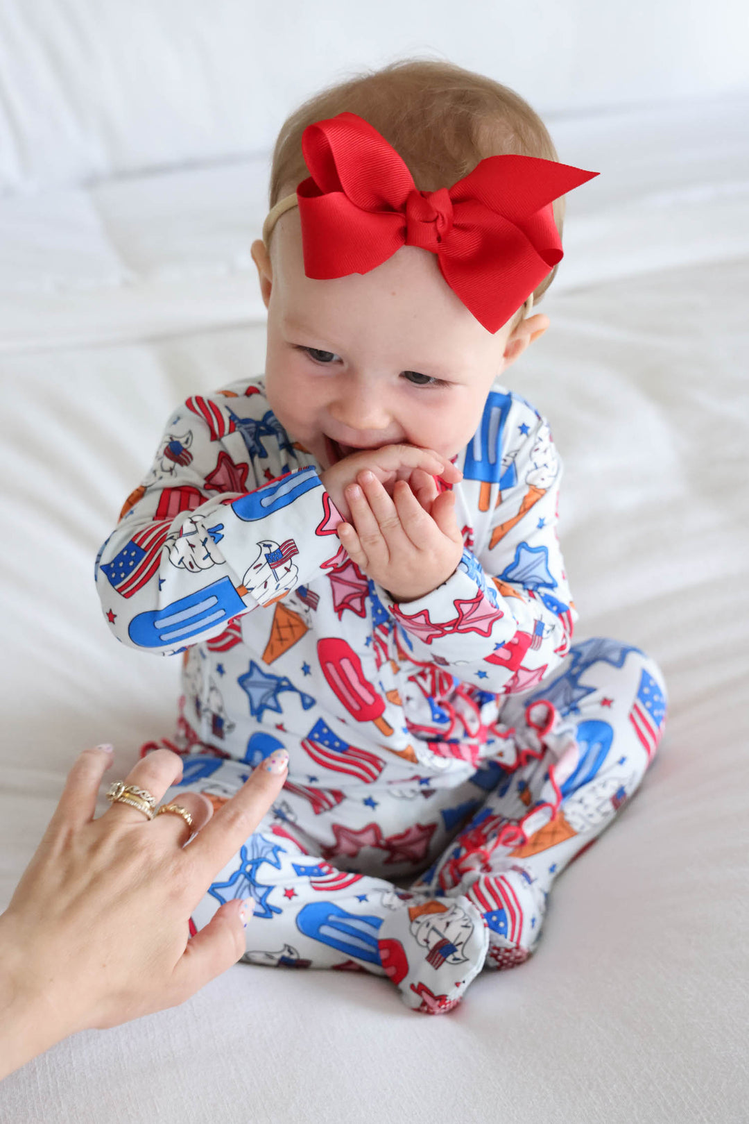 caden lane candy red ribbon bow headband on model - patriotic baby girl hair bow