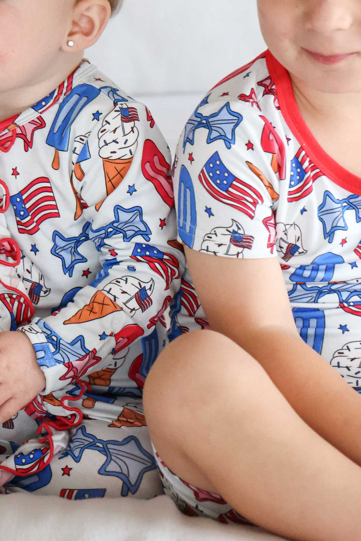 caden lane red white and cool ruffle footie lifestyle - patriotic bamboo 4th of july baby pajamas