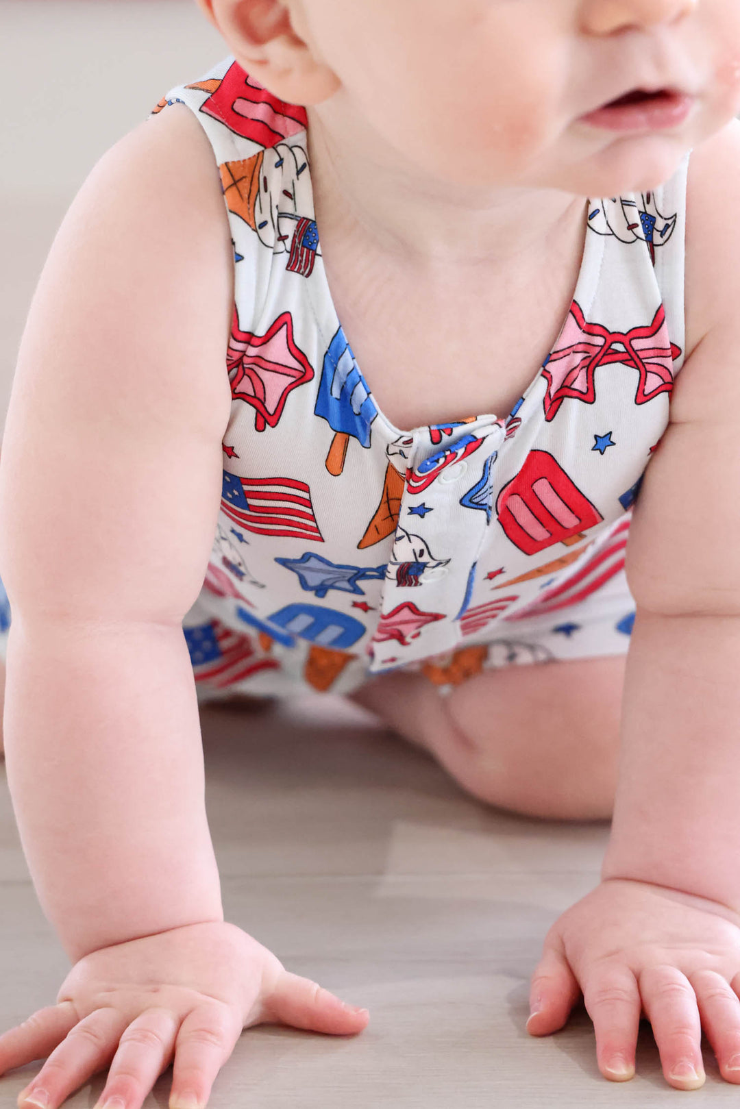 caden lane red white and cool sleeveless romper on model - 4th of july patriotic baby girl