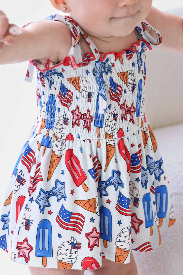caden lane 4th of july smocked twirl bodysuit - red white and cool patriotic bamboo baby girl
