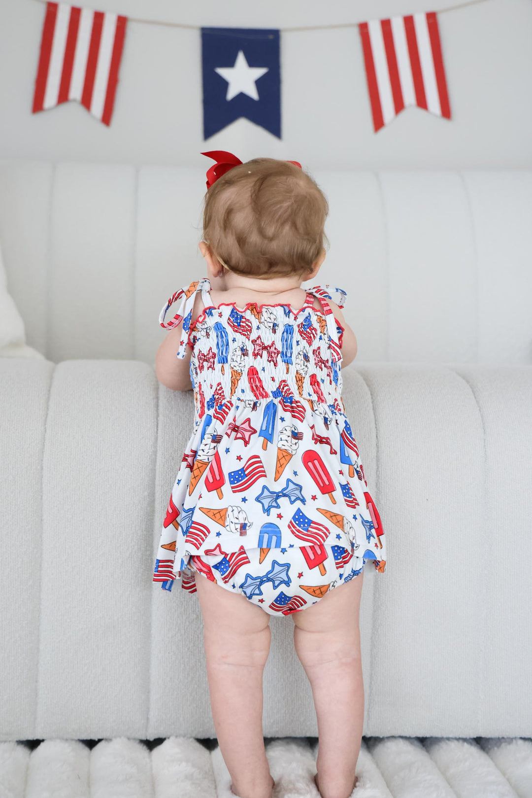 caden lane red white and cool smocked bodysuit flat lay - patriotic bamboo 4th of july infant