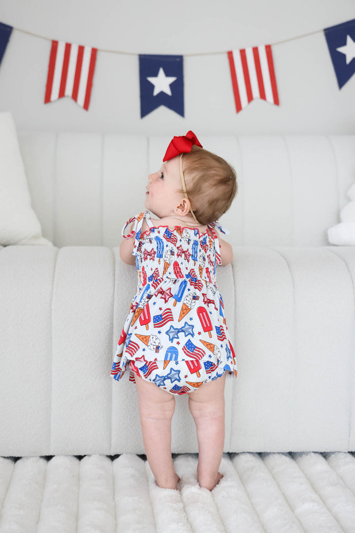 red white and cool bamboo smocked twirl bodysuit - caden lane 4th of july flags print baby onesie