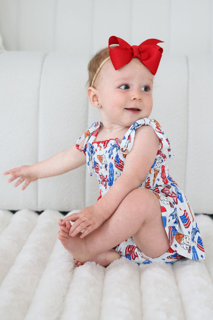 caden lane red white and cool smocked twirl bodysuit on model - 4th of july patriotic baby girl