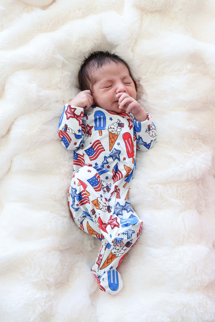 close-up of red white and cool zipper footie - caden lane bamboo 4th of july baby pajamas