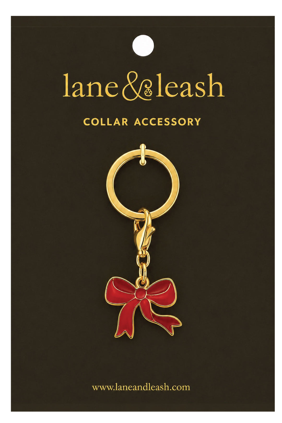 Lane & Leash red bow charm collar accessory on branded packaging card, gold ring with lobster clasp and enamel red bow charm