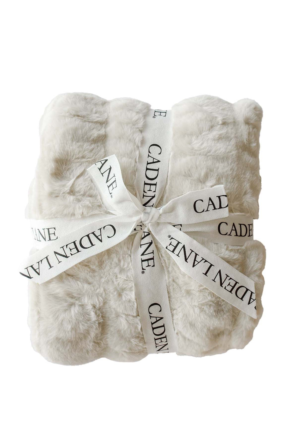Folded double-ruched faux fur baby blanket in sand tan, tied with a Caden Lane ribbon