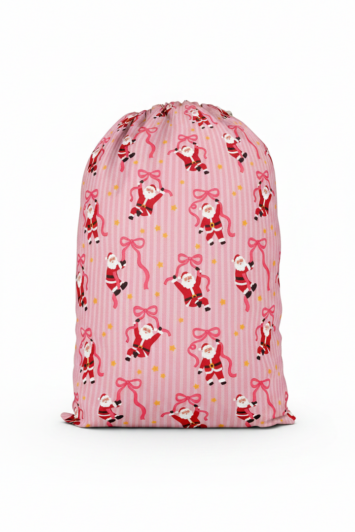 Caden Lane Jolly Ribbons Personalized Christmas Santa Sack back featuring an exclusive Santa and ribbon print on pink stripes, coordinating with matching family pajamas and holiday accessories.