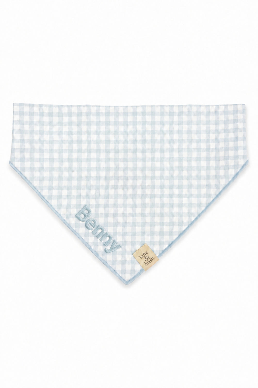 A Lane & Leash light blue and white gingham checkered pet bandana with the name 'Benny' embroidered in blue on one corner and a small beige brand tag on the opposite side, shown on a plain white background.