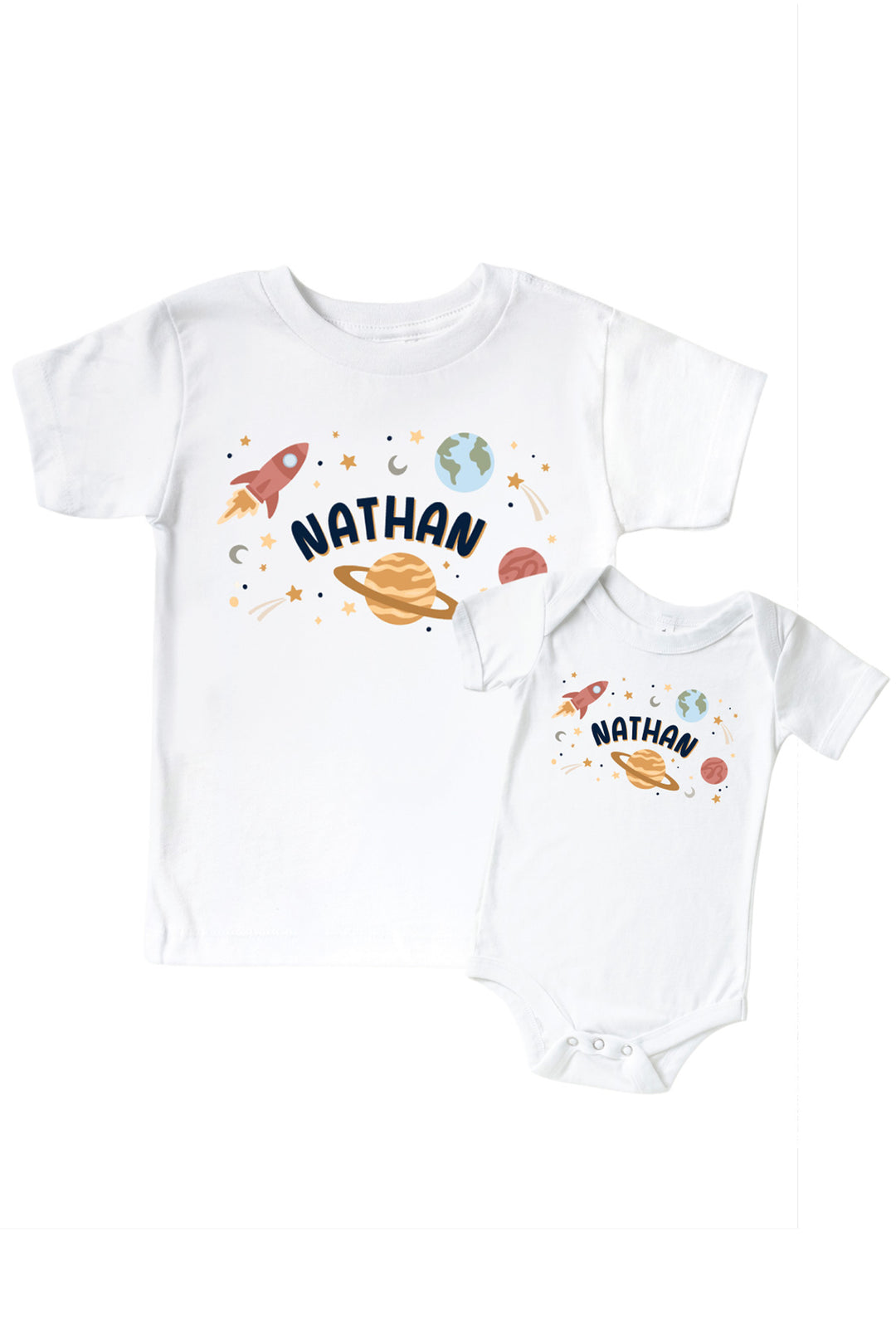 Flat lay of a matching Caden Lane white kids’ tee and bodysuit pair with a Stellar Snuggles Planets graphic featuring labeled planets and rockets.