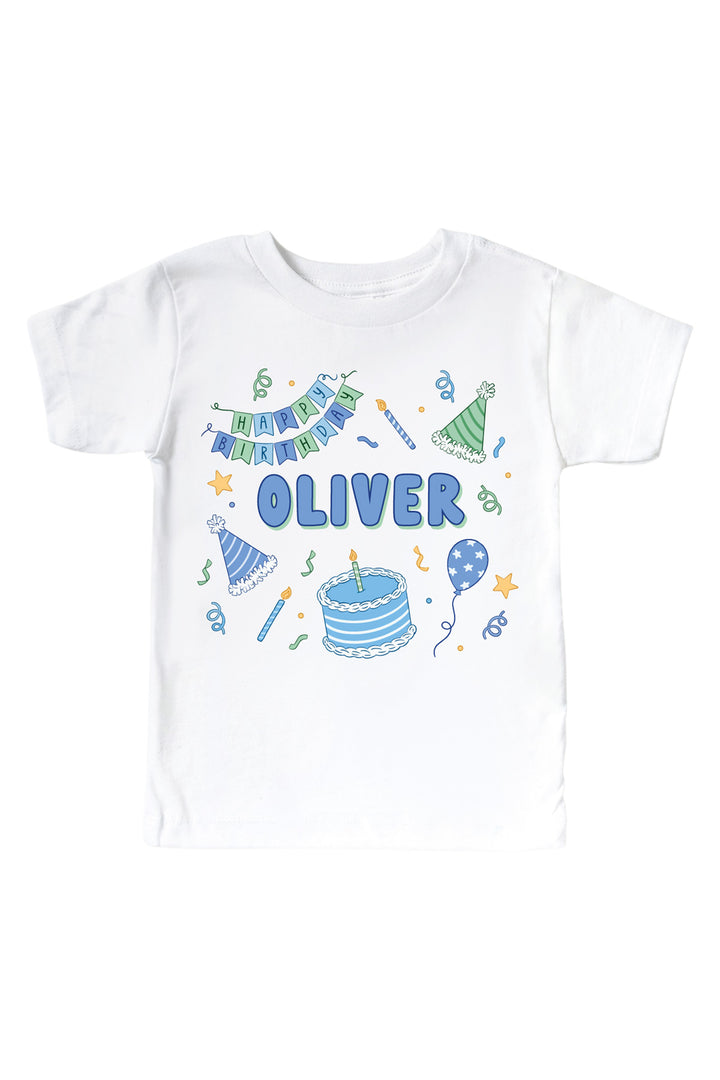 Caden Lane personalized Birthday Bash white kids' t-shirt with a blue and green "Happy Birthday" banner, party hats, cake, and the name "Oliver" in blue.