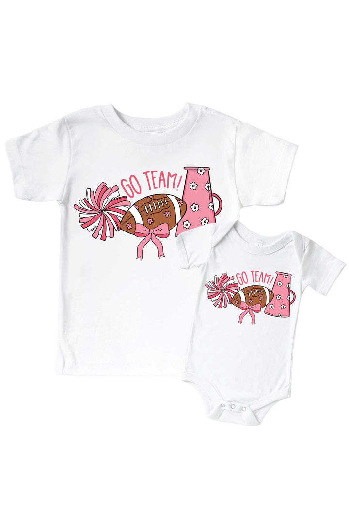 Caden Lane Graphic Bodysuit & Kids' Tee Go Team Pink — matching toddler-and-baby t-shirt set in white, featuring a "Go Team!" cheerleading graphic with pink pom poms, a floral football, and megaphone design.