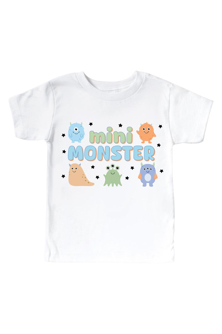 Caden Lane white kids t-shirt with "Mini Monster" graphic in green and blue lettering, featuring blue, orange, tan, green, and purple cartoon monsters and stars