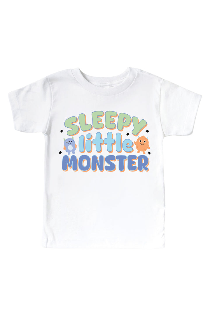 Caden Lane white kids t-shirt with "Sleepy Little Monster" graphic in green and blue lettering, featuring blue and orange cartoon monsters and stars