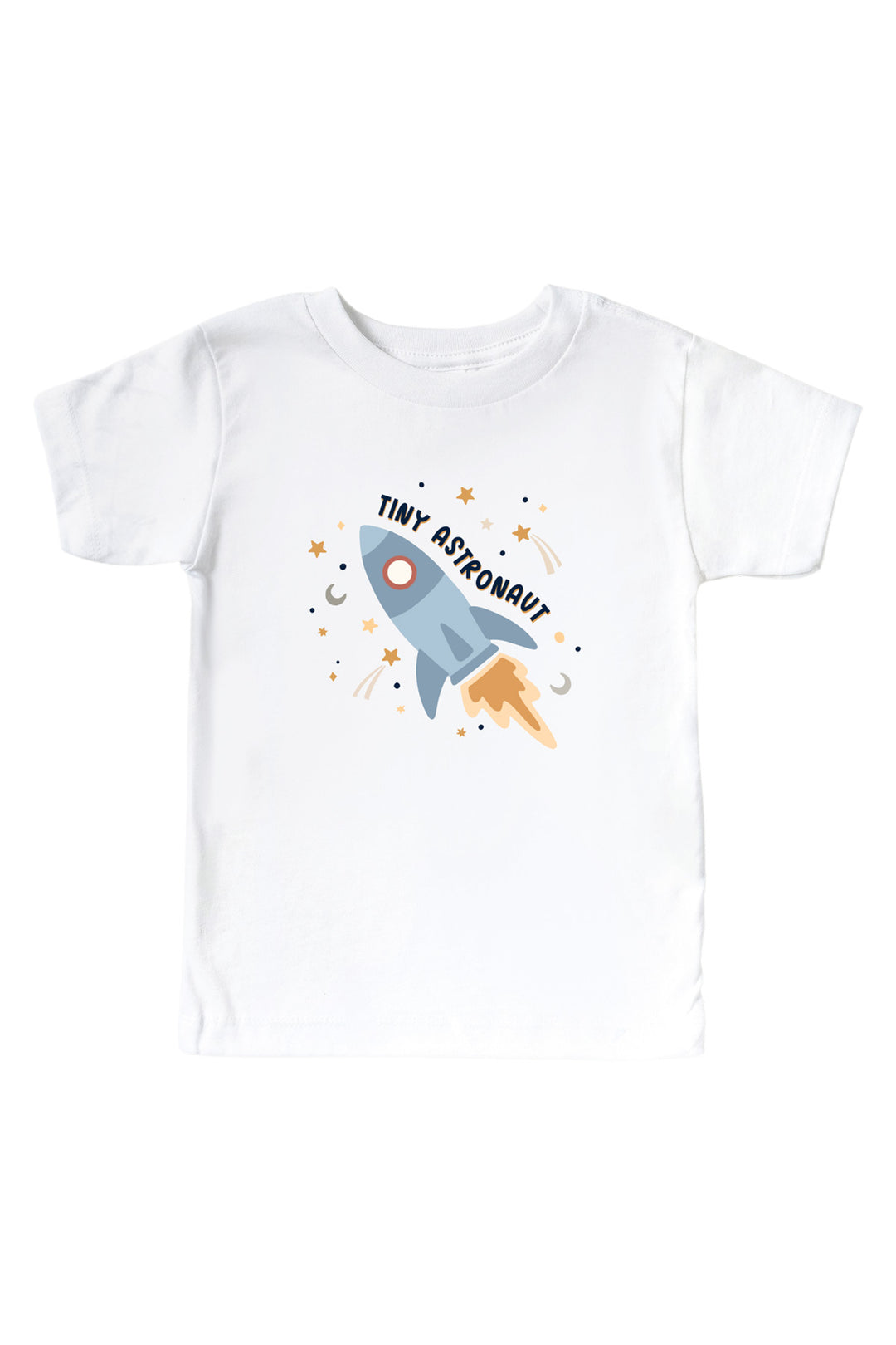 Flat lay of a Caden Lane white kids’ tee with a Stellar Snuggles graphic featuring a blasting blue rocket and shooting stars, reading “Tiny Astronaut.”