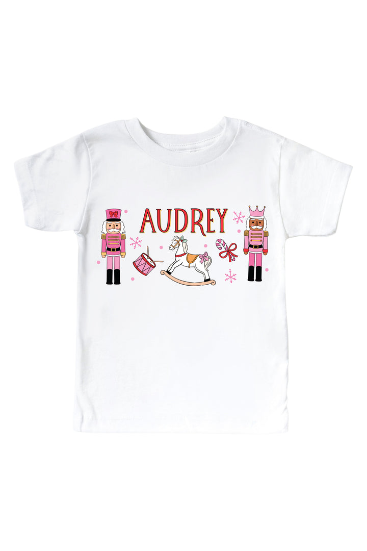 Shop the 'Personalized Toy Soldier Pink' Graphic Bodysuit or Kids' Tee | White, a custom Christmas style for babies and kids, perfect for holiday photos, parties, and gifting.
