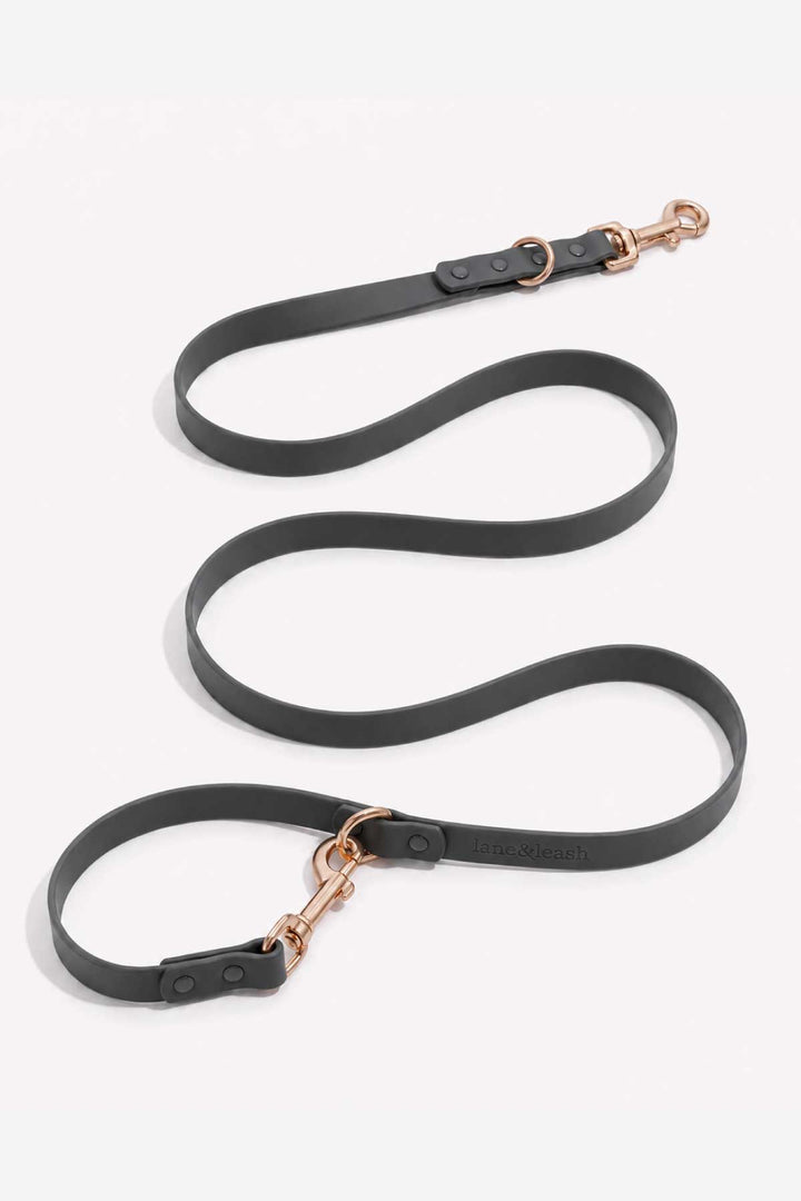 Waterproof silicone dog leash in charcoal gray, showing full length with rose gold snap hook clasp and loop handle