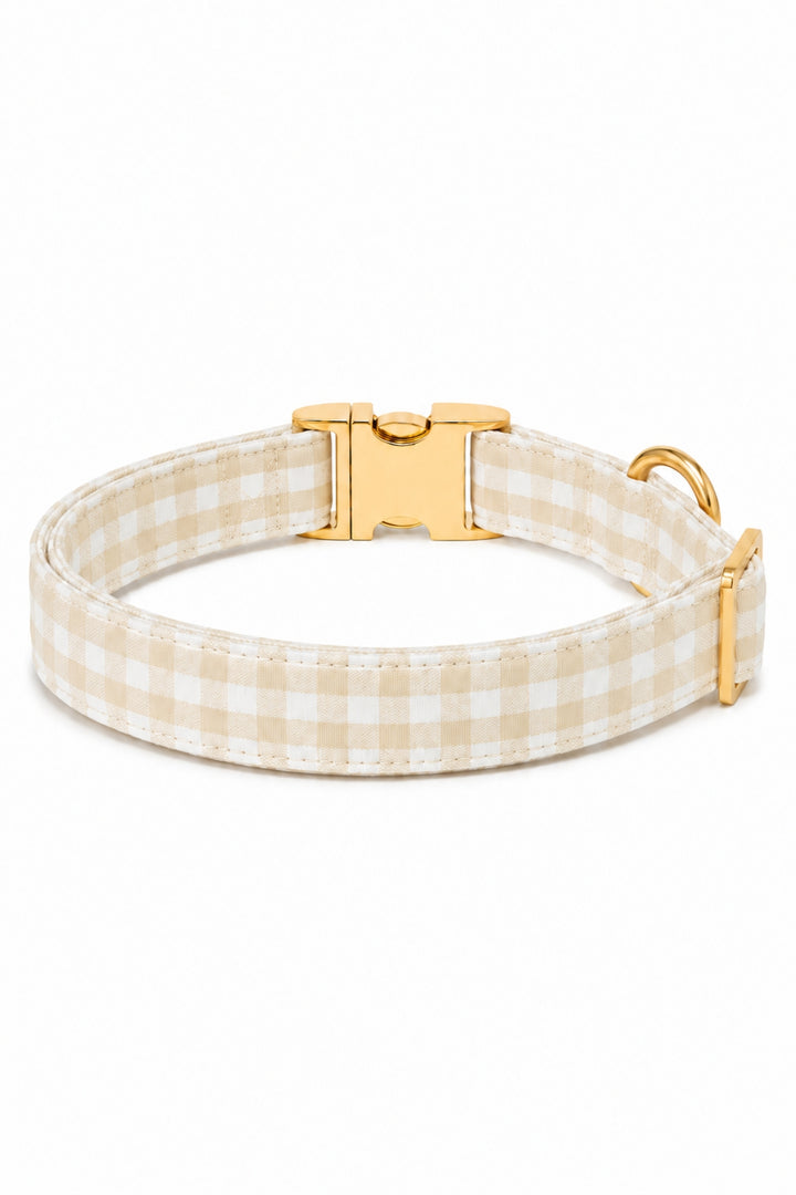 A Lane & Leash beige and white gingham check dog collar with a gold-tone metal buckle and D-ring, shown on a clean white background.