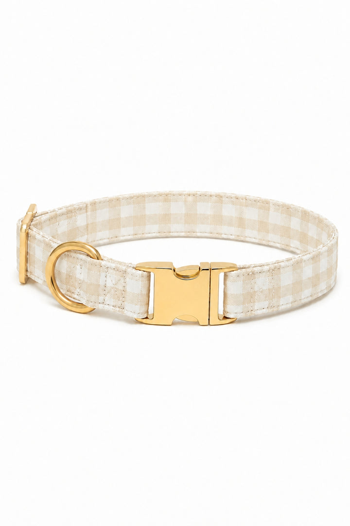 A Lane & Leash beige and white gingham check dog collar with a gold-tone metal buckle, D-ring, and adjustment slider, shown on a plain white background.
