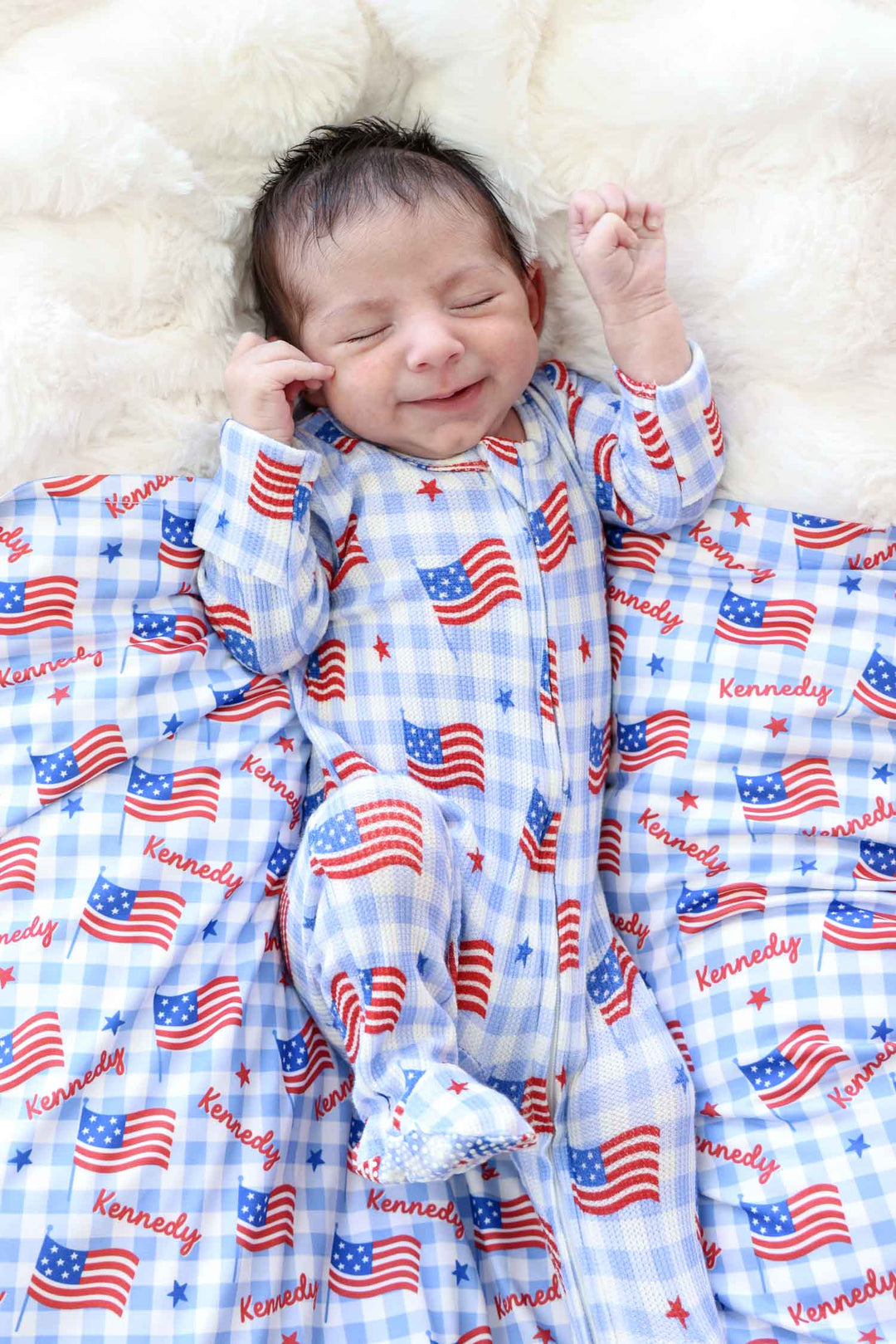 baby wearing bamboo waffle swaddle blanket in star spangled picnic - 4th of july