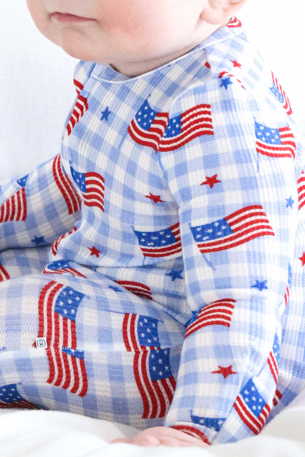 baby wearing bamboo waffle zipper footie in star spangled picnic - 4th of july