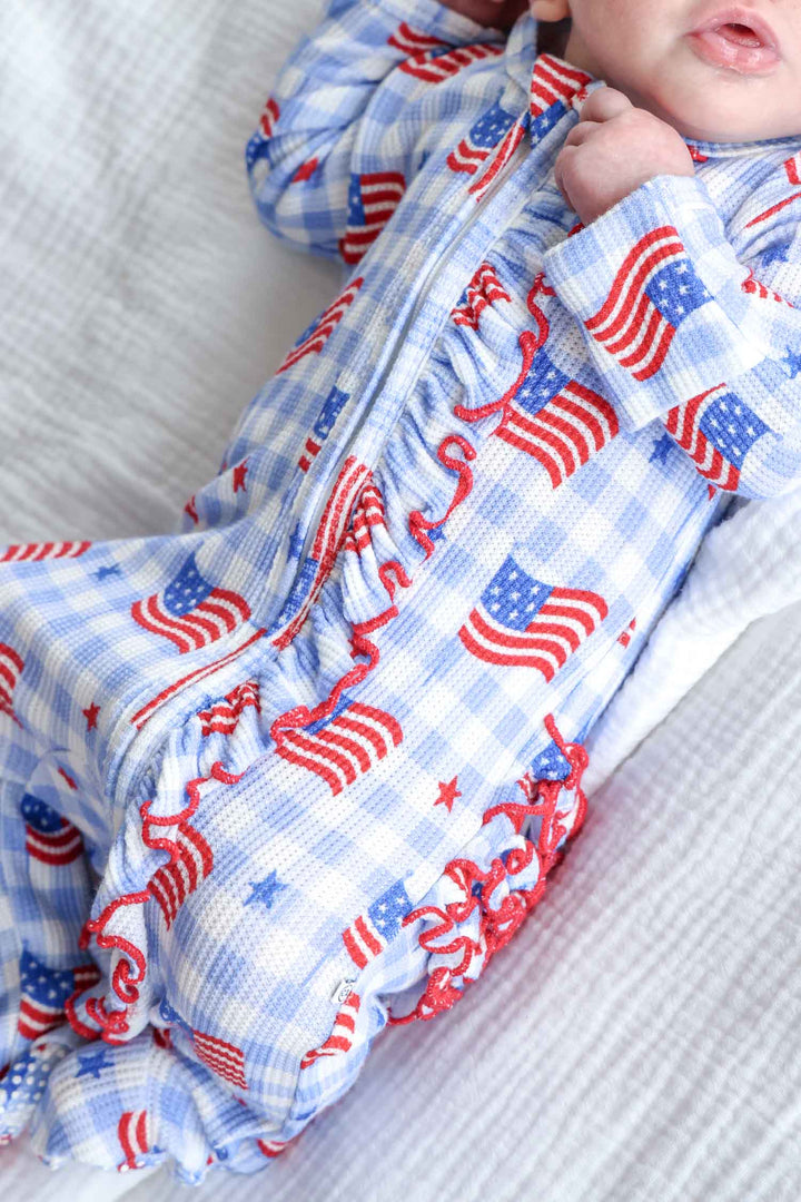 lifestyle photo of bamboo waffle ruffle zipper footie - star spangled picnic